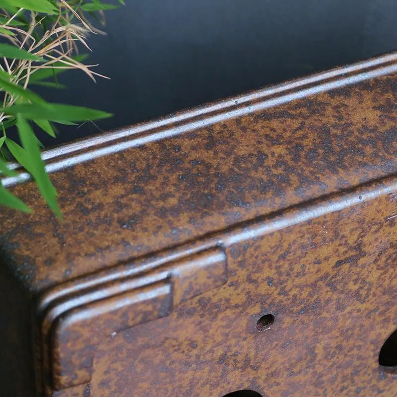 Handmade rectangular purple sand bonsai pot with natural firewood-burnt glaze, shown empty on a wooden surface.