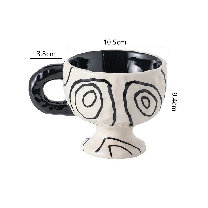 Handmade irregular solid colour ceramic mug on a table, showing its unique shape.