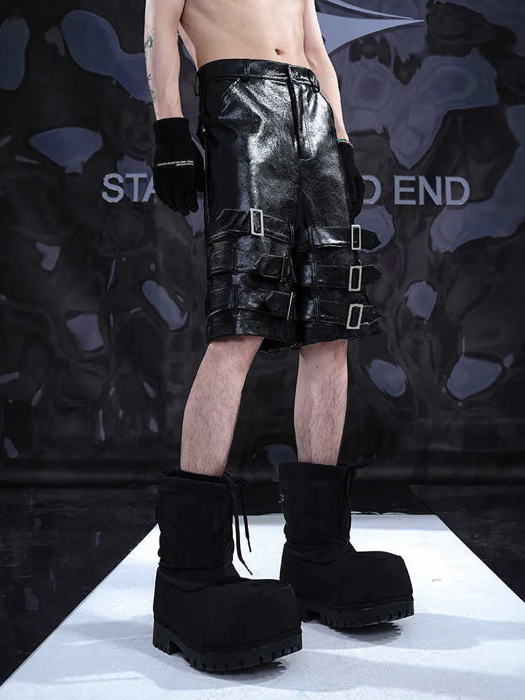 Black men's leather-look casual cropped shorts with ring details on a low-rise waist.