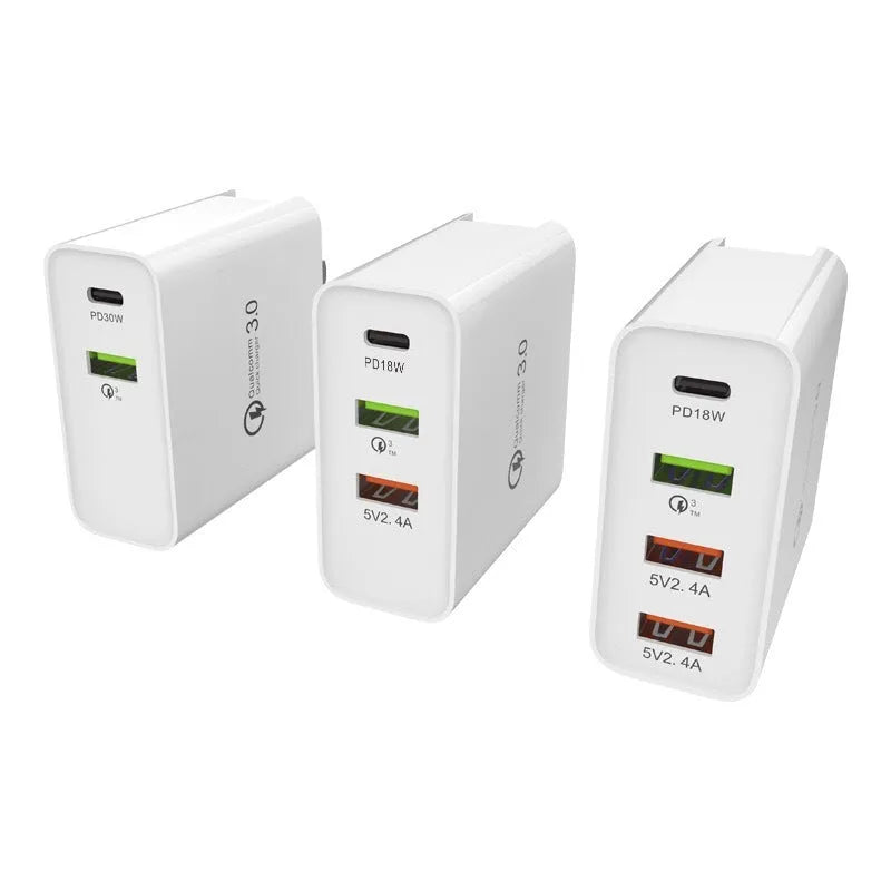 White and black multi-port fast charge USB wall charger with PD and QC support on a wooden surface.