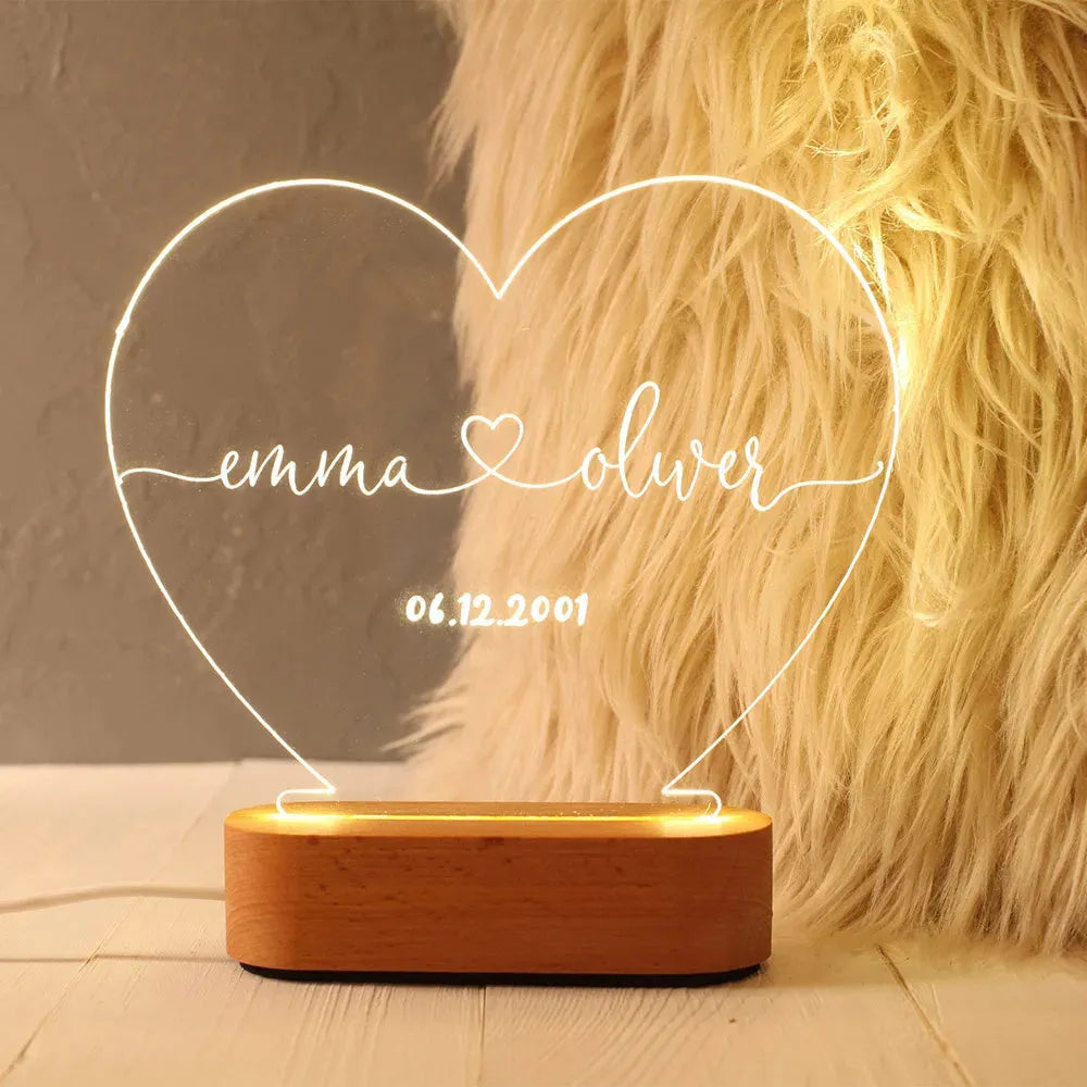 Custom acrylic LED night light with engraved names and date for Valentine's Day.