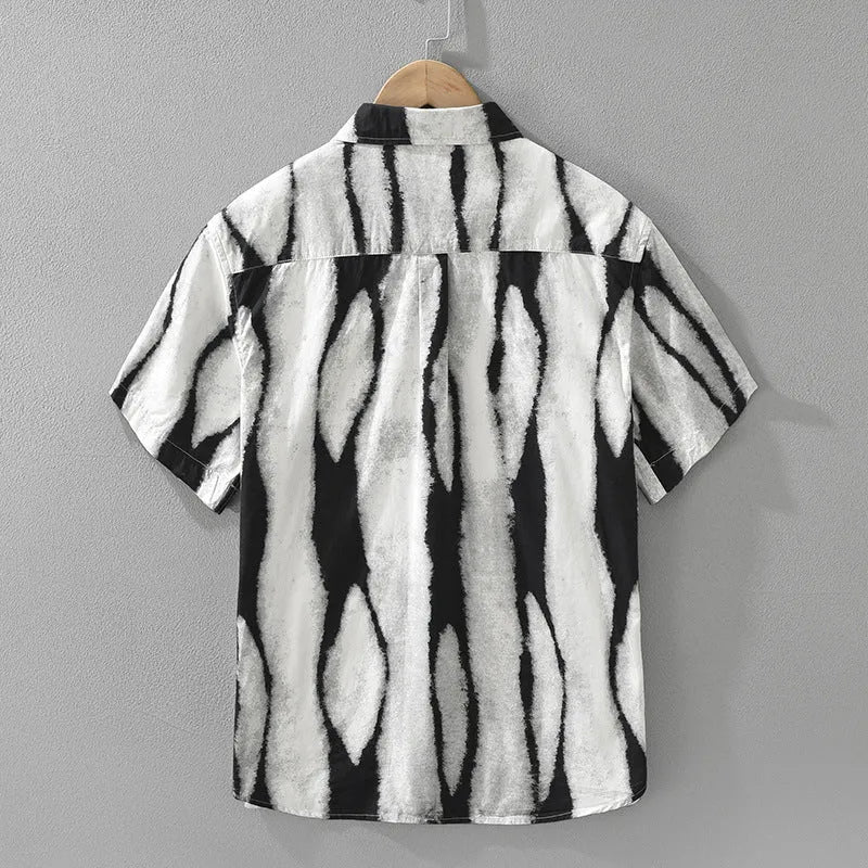 Man wearing a black and white striped retro-style short sleeve cotton shirt with a loose cardigan fit.