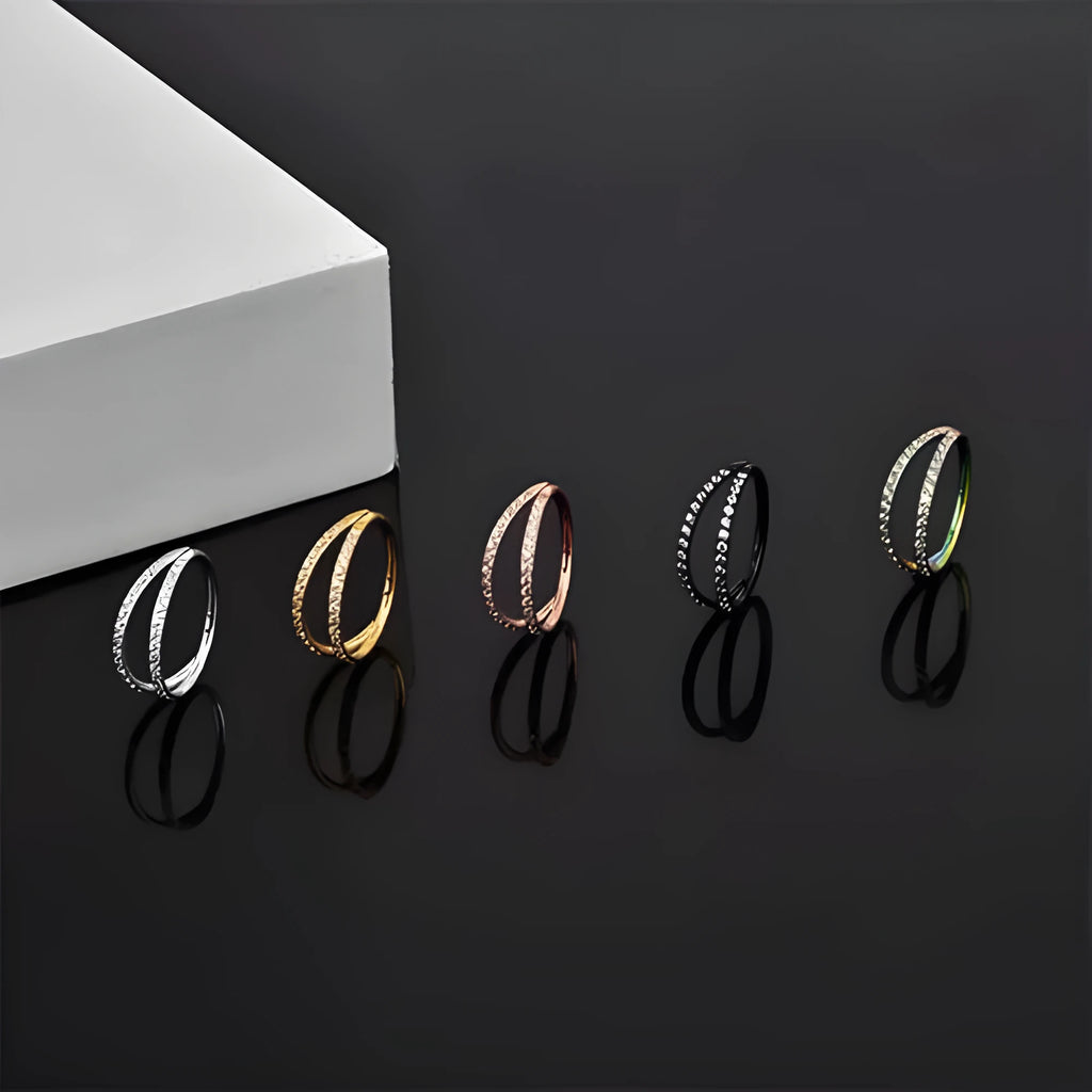 G23 titanium alloy puncture-style nose ring on a plain background showing steel and gold colour options.