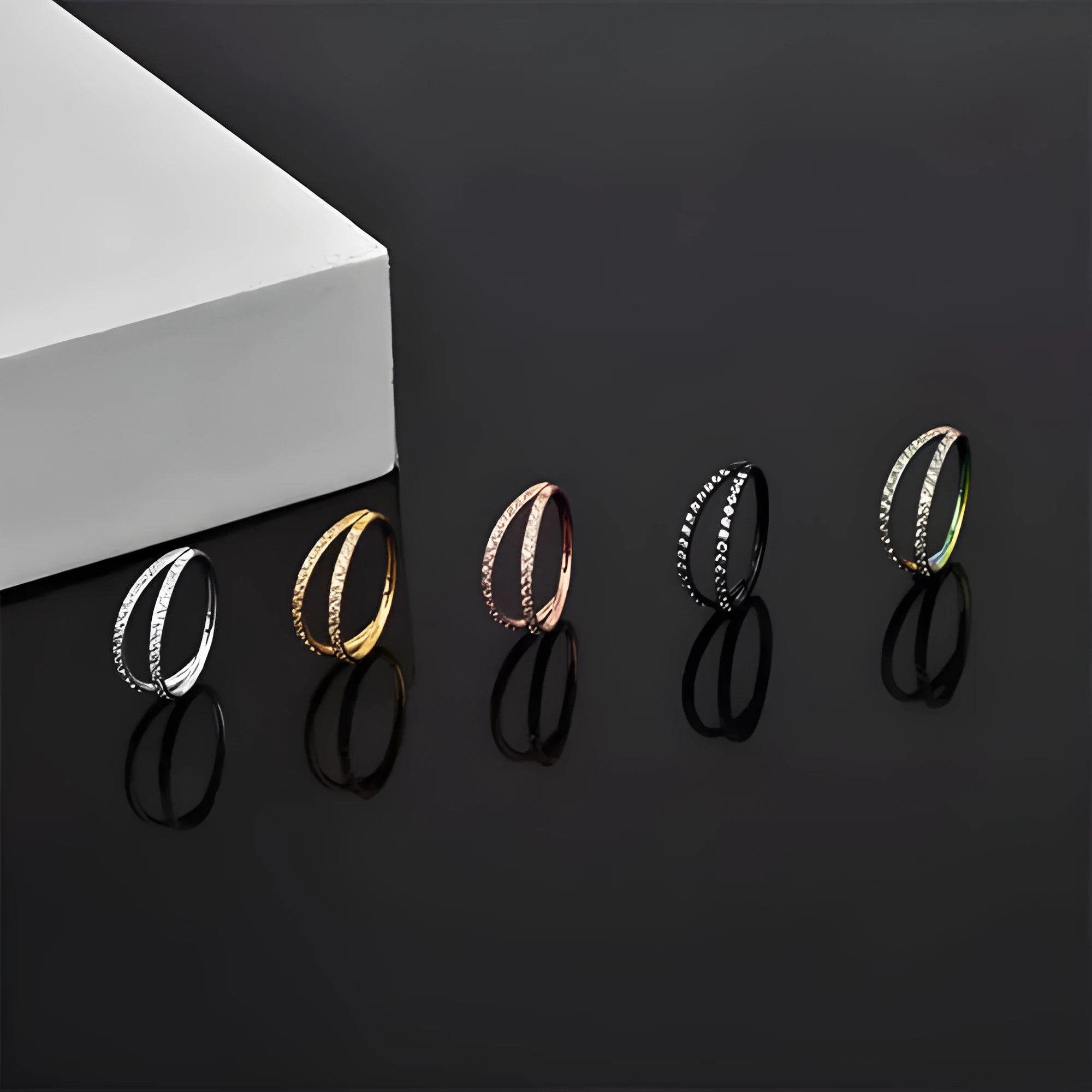 G23 titanium alloy puncture-style nose ring on a plain background showing steel and gold colour options.