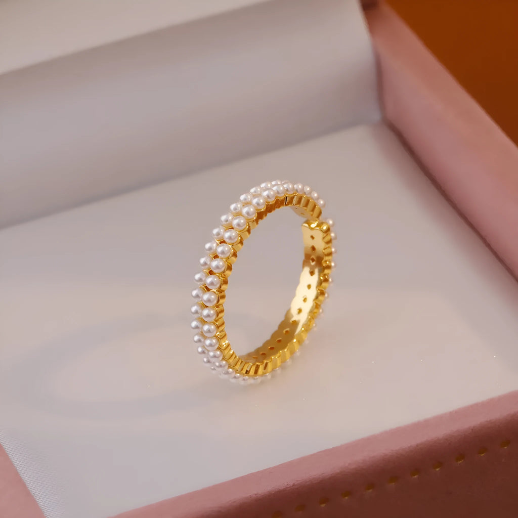 Gold electroplated pearl ring with open mouth geometric design on female hand