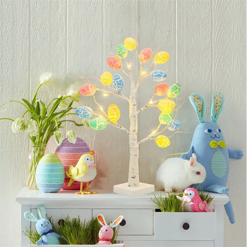 White plastic birch tree Easter decoration with warm white LED lights and hanging coloured eggs on adjustable branches.