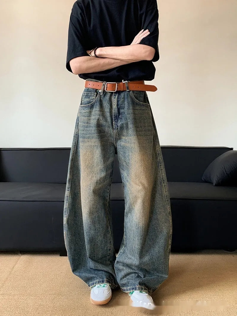 Man wearing Retro Blue distressed wide-leg denim jeans with a slimming silhouette and mid-waist fit.