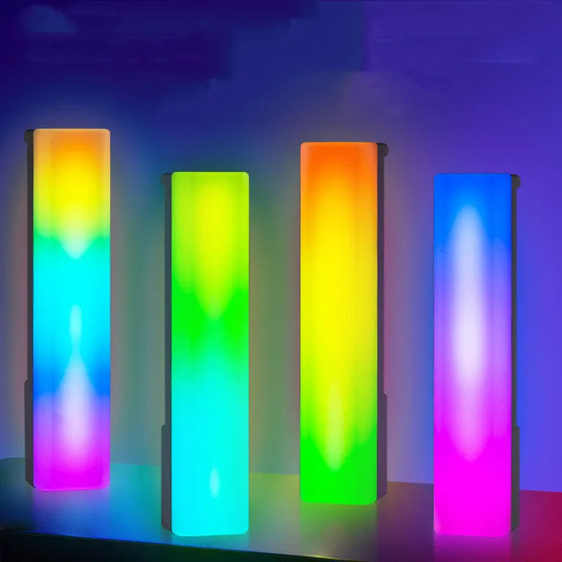 3D RGB music rhythm table lamp with voice control in black or white shell on a desk.
