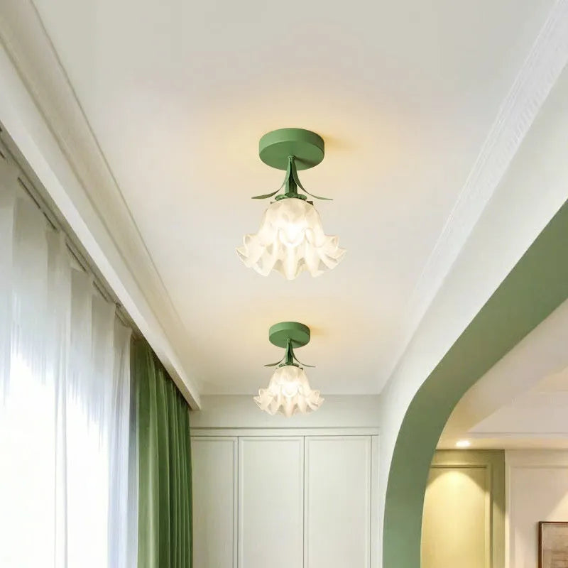 Cream coloured Linglan flower inspired corridor wall light with modern simple design on a white background.
