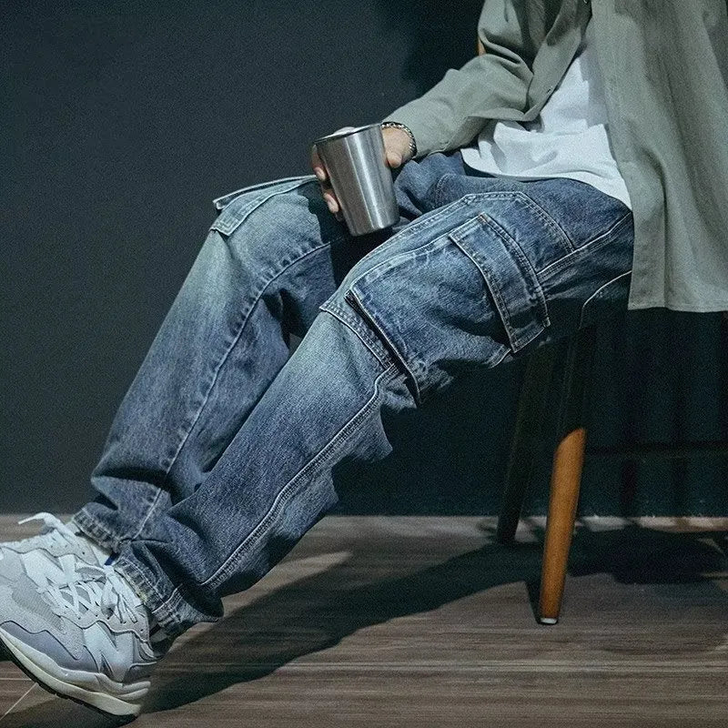 Men's loose straight-leg blue stretch denim jeans with a zip fly, shown on a hanger.