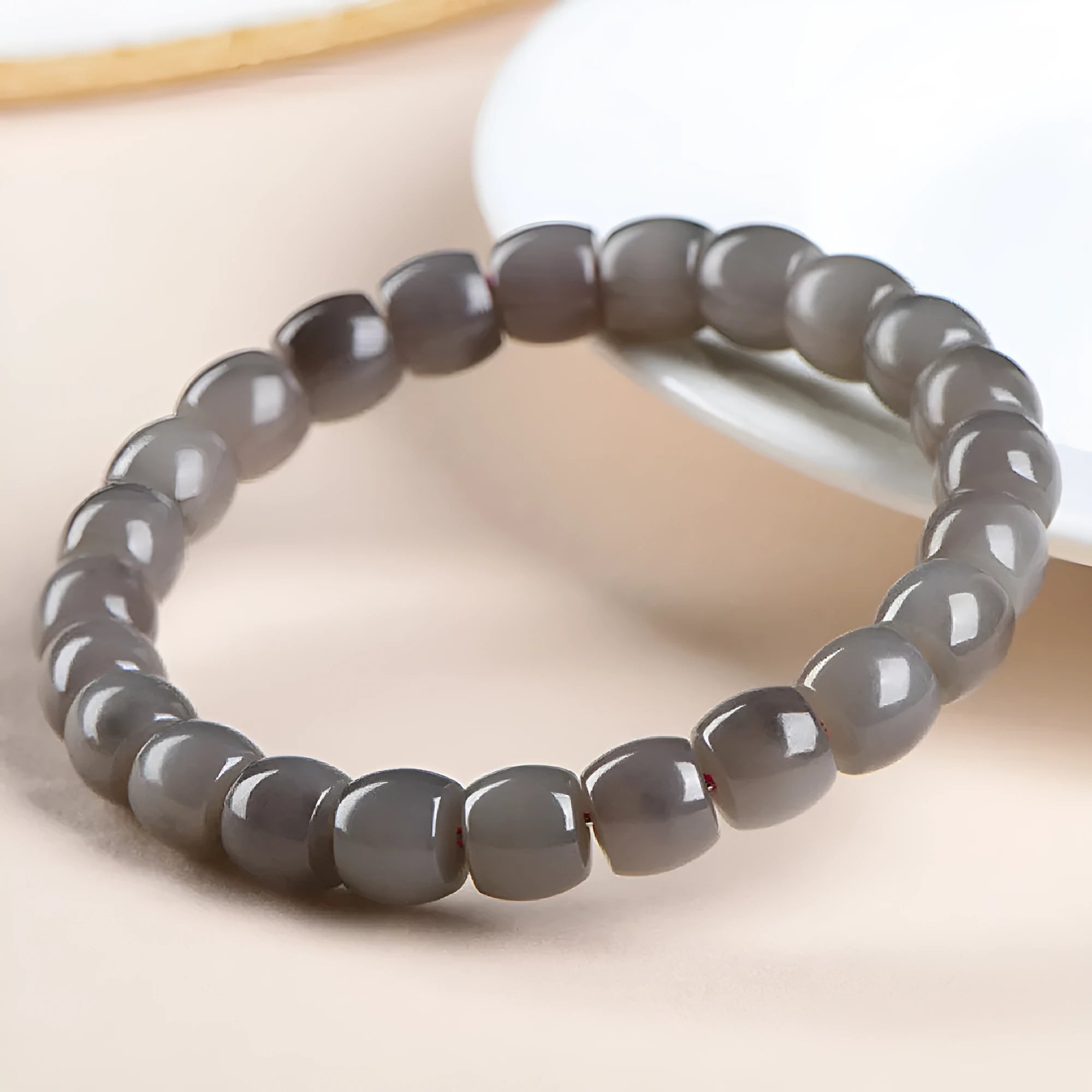 Hetian jade Smokey Violet bracelet with straight cut beads on a wrist.
