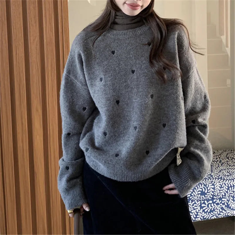 Women's loose fit acrylic pullover sweater in milky white, showing crew neck and long sleeve design.