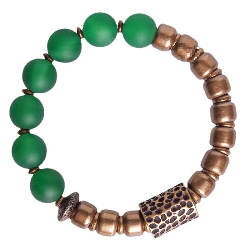 Retro ethnic style couples bracelet with green or red agate beads on a wrist.