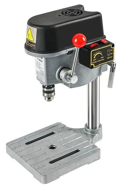 Mini bench drill and milling machine with heavy duty bench pliers on a workbench.