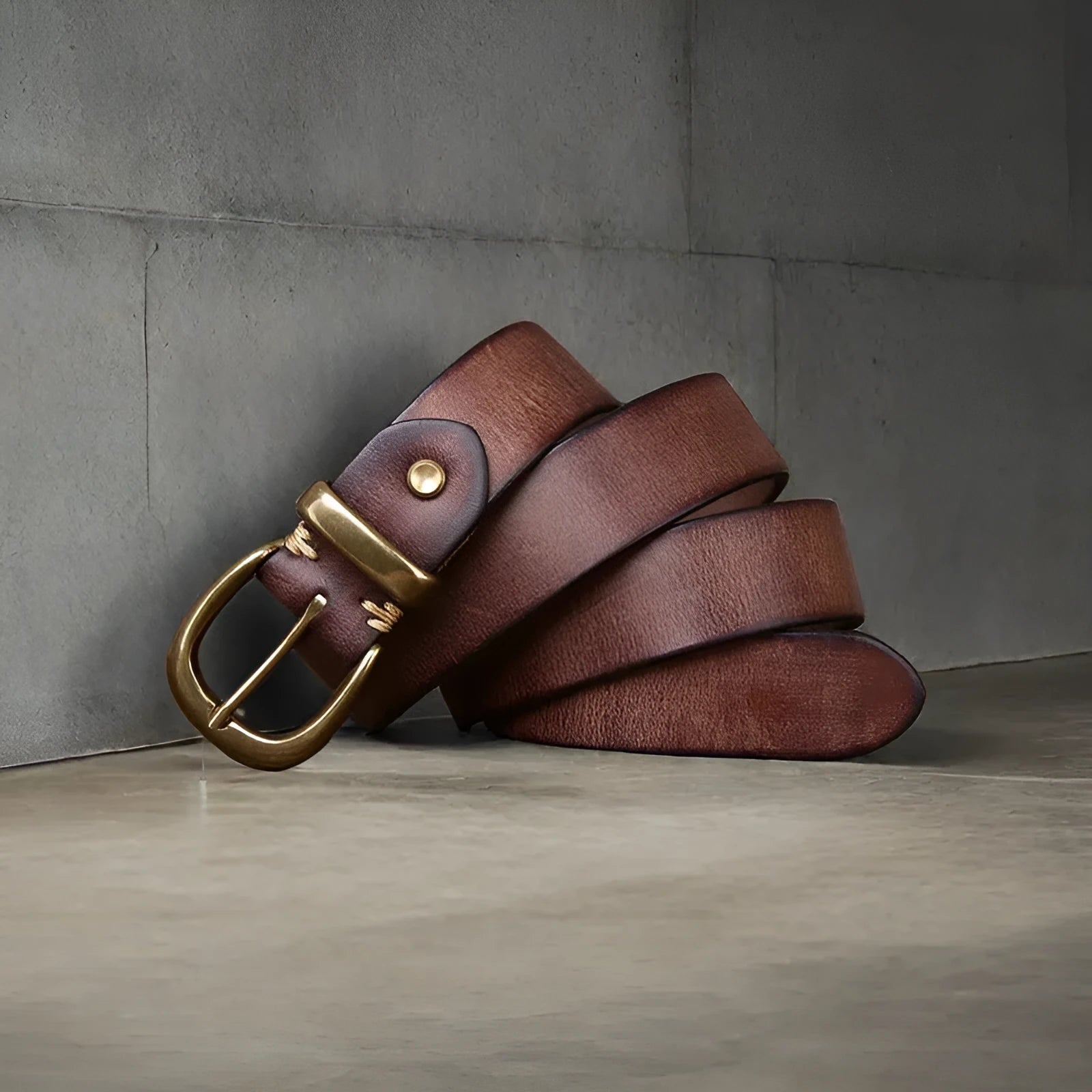 Men's brown casual leather belt with a copper pin buckle shown on a pair of jeans