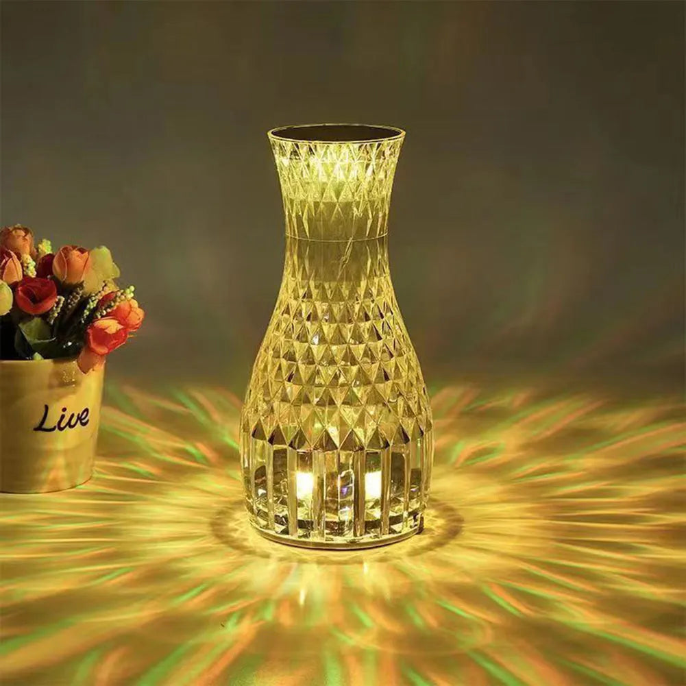 Vase-shaped crystal table lamp with diamond-like LED lighting on wooden surface