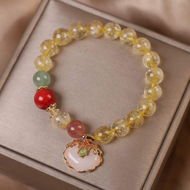 Women's adjustable alloy bracelet with a detailed natural citrine jade ruyi pendant in yellow tones.
