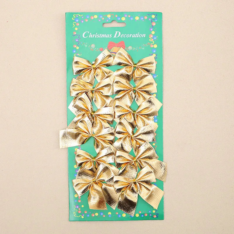 Red, gold, red gold, and silver 5 cm polyester Christmas bow ornaments on a green tree branch.