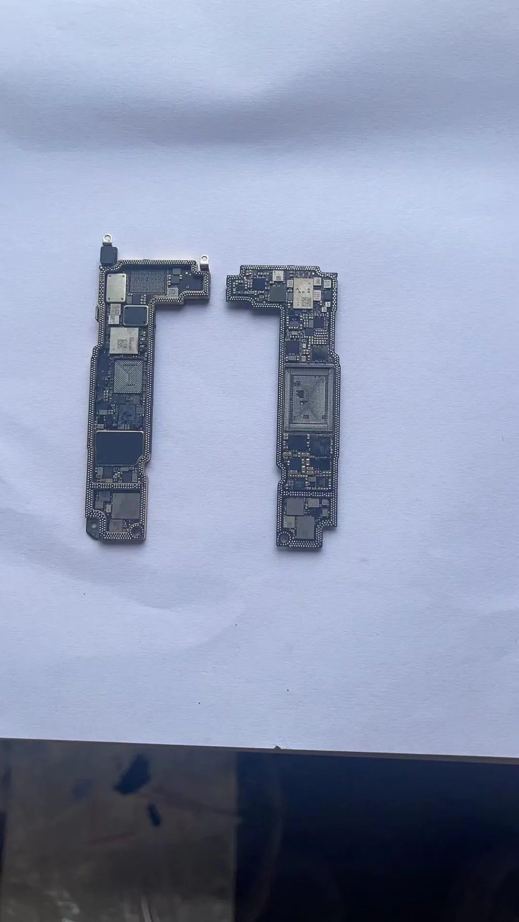 Silver iPhone logic board spare part for iPhone 12, 12 mini, 12 Pro, and 12 Pro Max repair