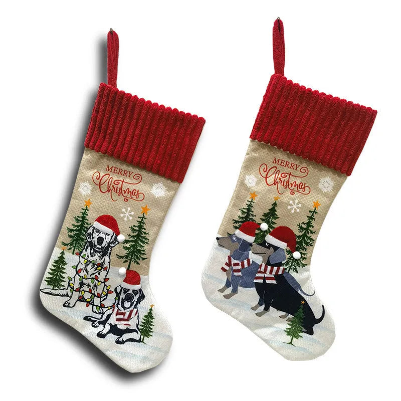 Red and green cloth Christmas stocking pendant for pets, hanging on a tree branch.