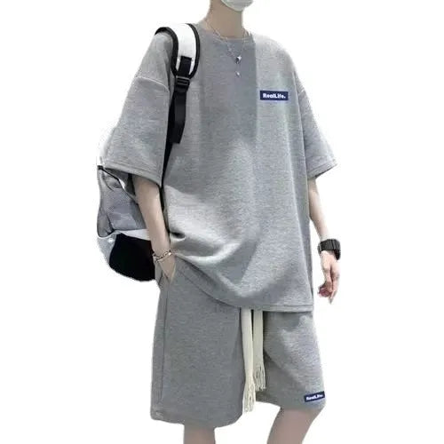 A waffle-textured leisure sports suit consisting of a short-sleeve top and shorts in a neutral colour.