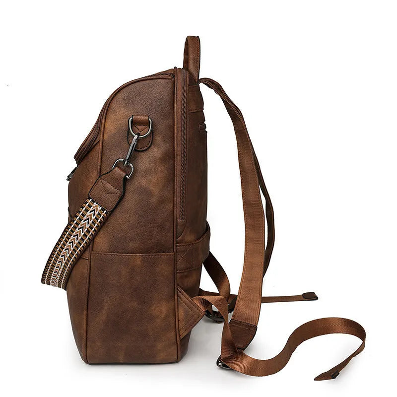 Retro solid colour PU backpack with curved shoulder straps shown in black.