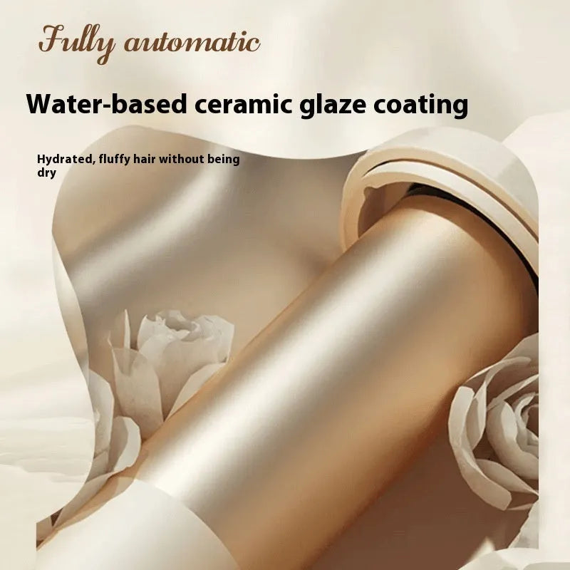 White and pink automatic hair curler with 32mm ceramic barrel and auto-clamp feature on a table.