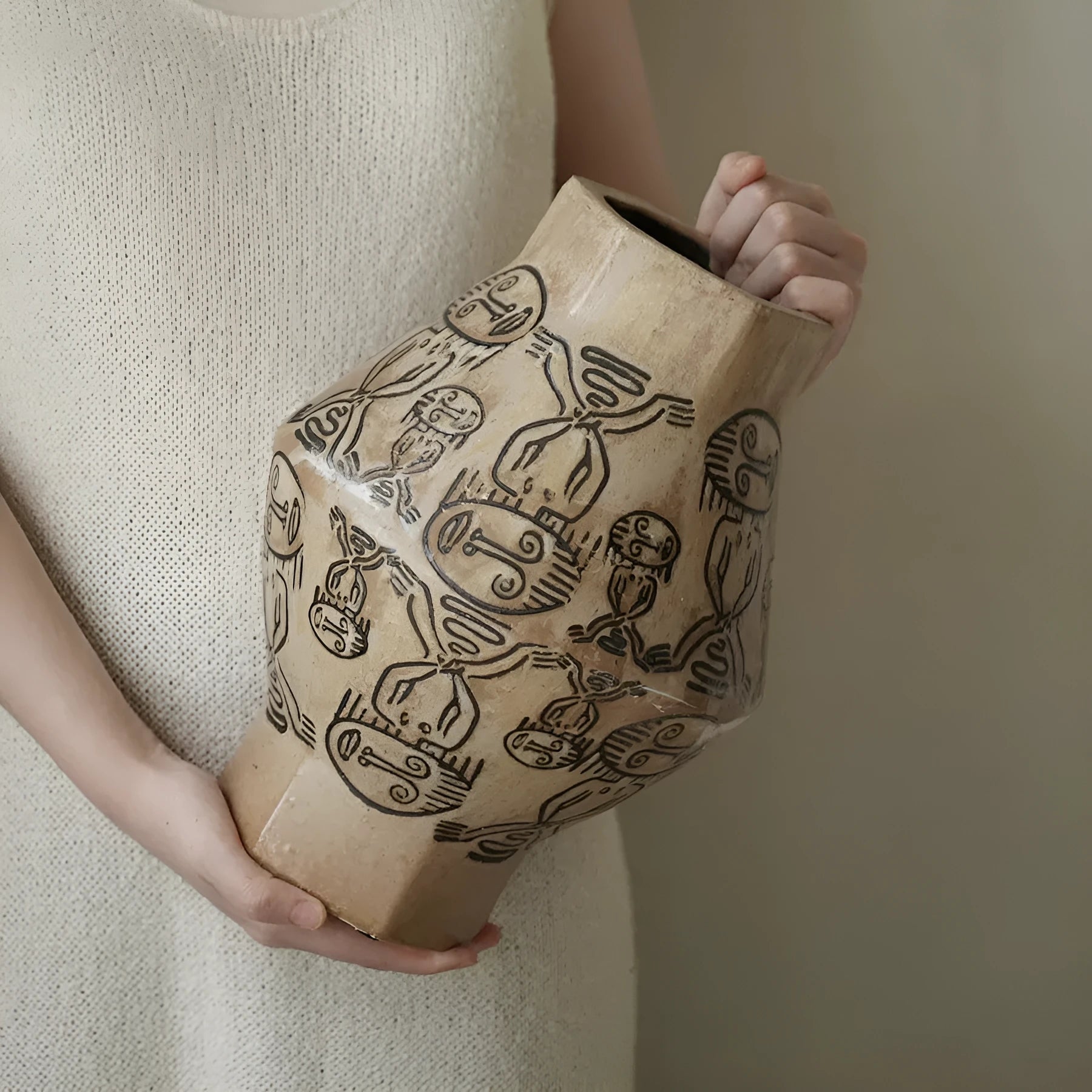 Hand-painted cylindrical ceramic vase with vintage carved tribal totem patterns in high or low style.