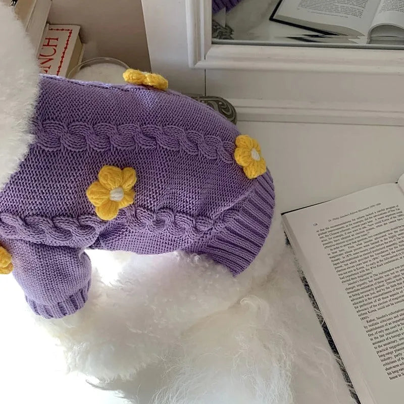 Purple flower print knitted dog jumper shown on a small dog, demonstrating the floral pattern and fit.