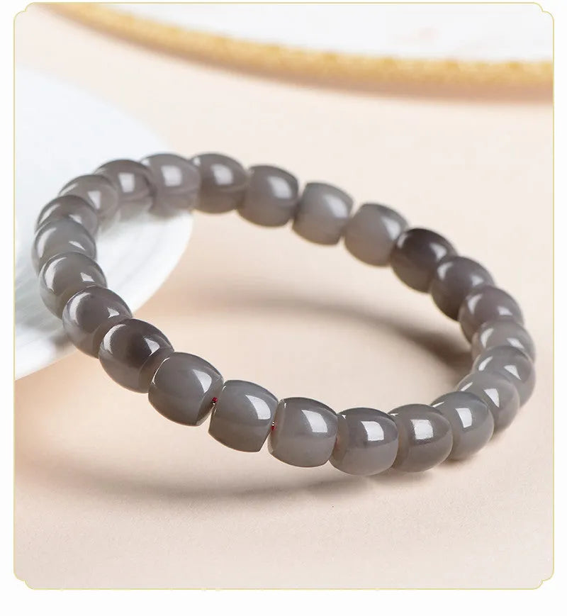 Hetian jade Smokey Violet bracelet with straight cut beads on a wrist.