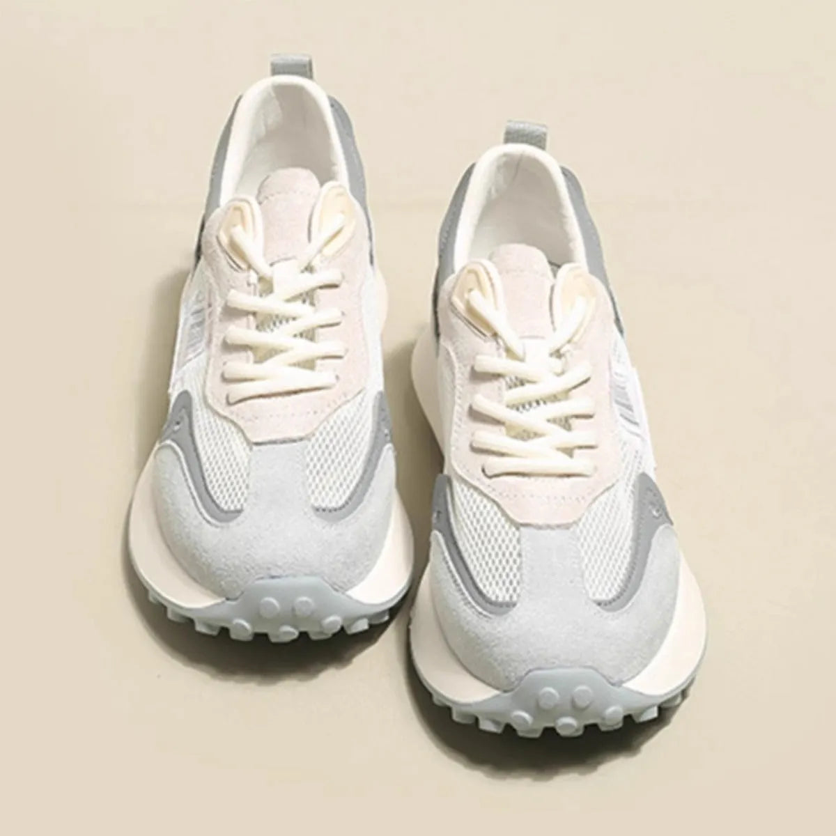 Women's grey and pink retro sneaker with low top design and round toe