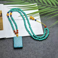 Turquoise mesh flower lucky pendant necklace on an adjustable ball bead chain.