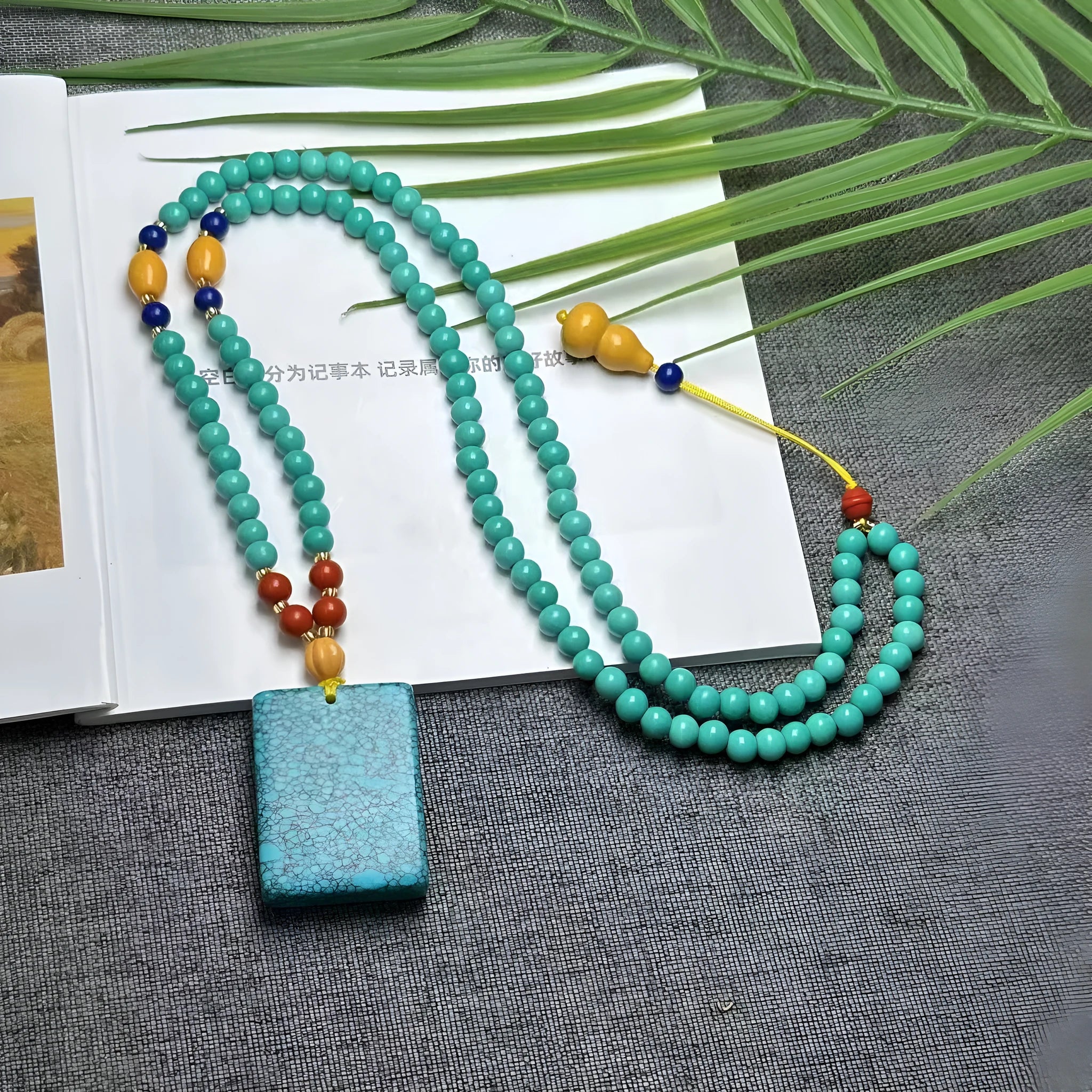 Turquoise mesh flower lucky pendant necklace on an adjustable ball bead chain.