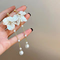 Women's acrylic shell pearl tassel earrings with 8.8cm drop length showing four different clip style options