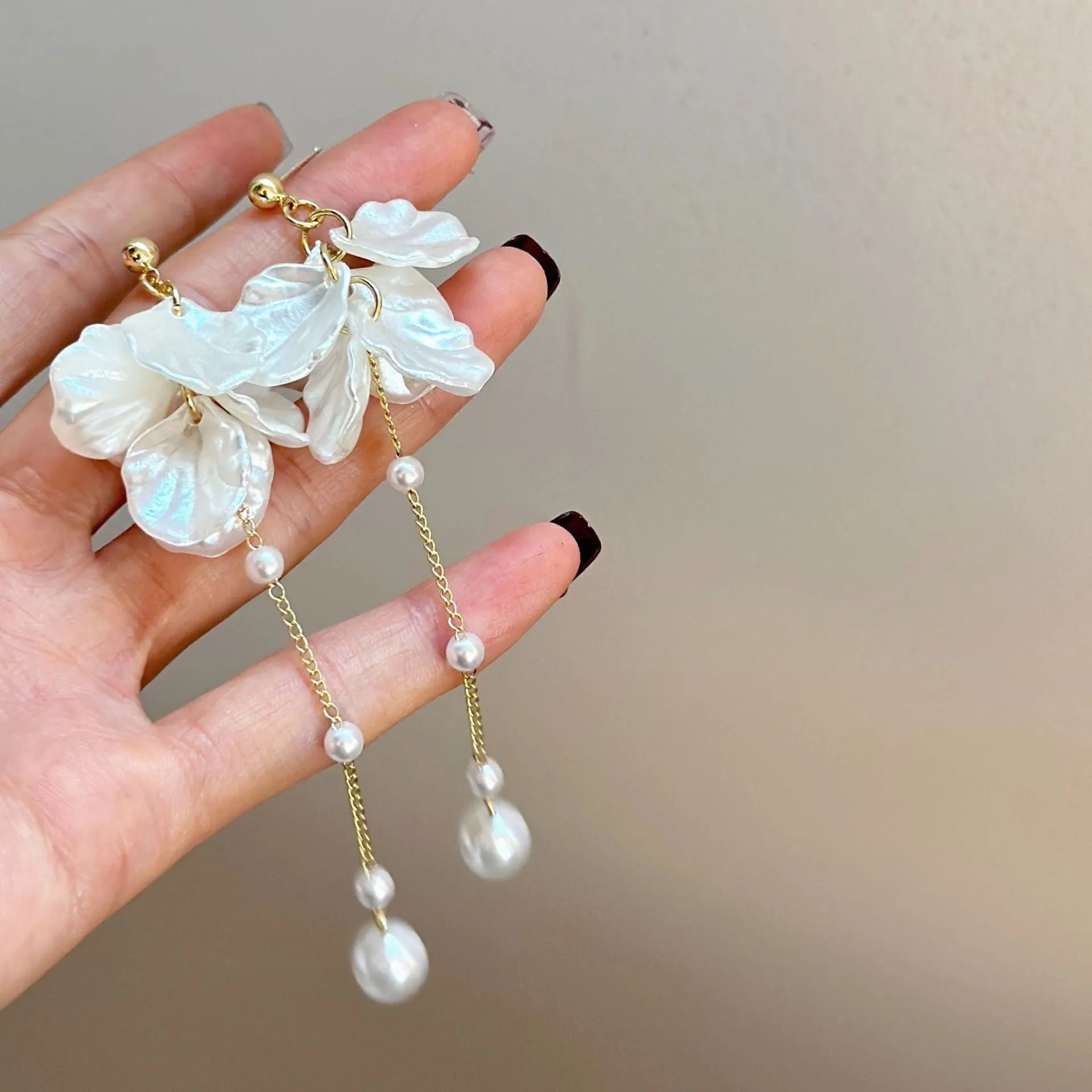 Women's acrylic shell pearl tassel earrings with 8.8cm drop length showing four different clip style options
