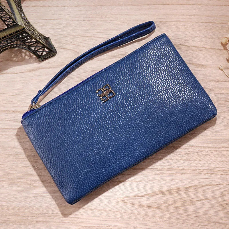 Long slim wine red PU leather wallet handbag with a top zip, shown open to reveal card slots and a phone pocket.