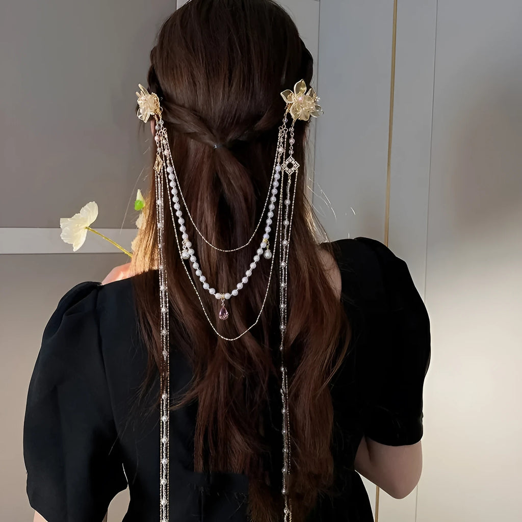 Gold-coloured acrylic hairpin with a long tassel and diamond-treated flower decoration.