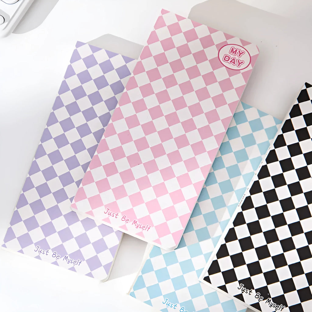 Ins style A5 grid notebook with coloured embossed fruit design cover on a desk