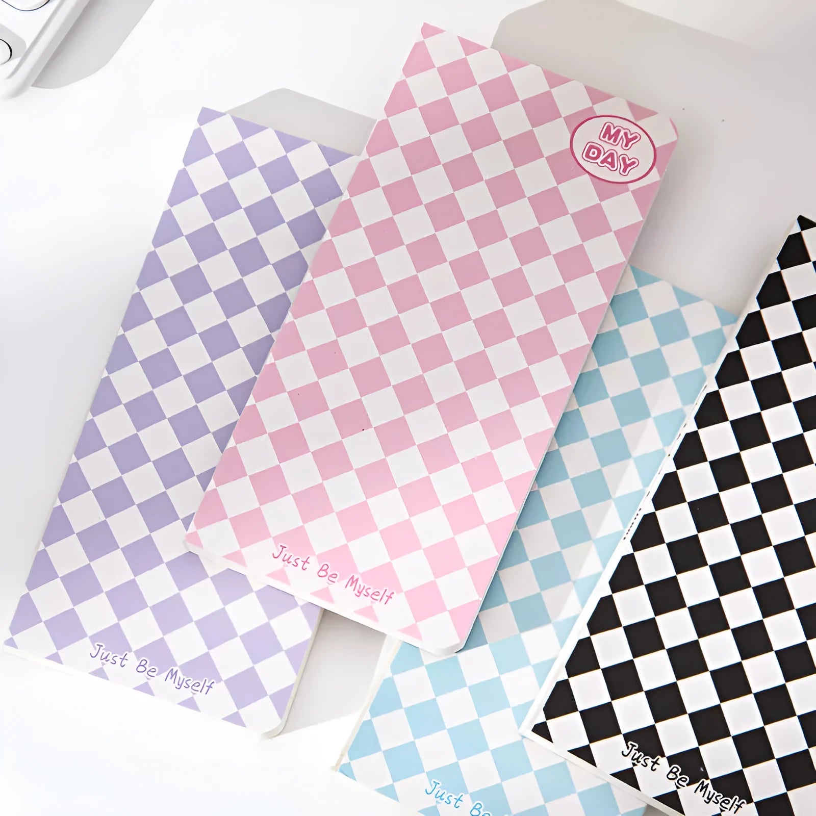Ins style A5 grid notebook with coloured embossed fruit design cover on a desk