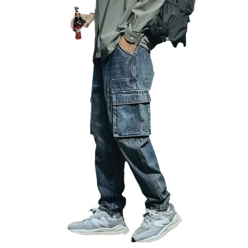 Men's loose straight-leg blue stretch denim jeans with a zip fly, shown on a hanger.