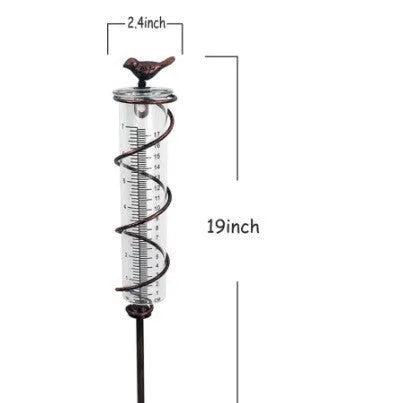 Cast iron bird-shaped rain gauge with glass measurement tube showing 1-20 scale and 800ml capacity