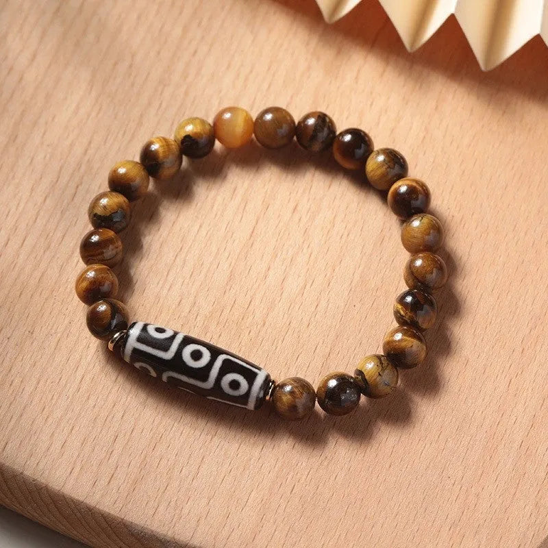 Single circle ethnic Tigereye bead Buddha rosary bracelet on a wrist, showing unisex design.