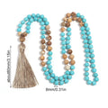 Handmade blue pine turquoise stone mala necklace with ball beads on a white background.
