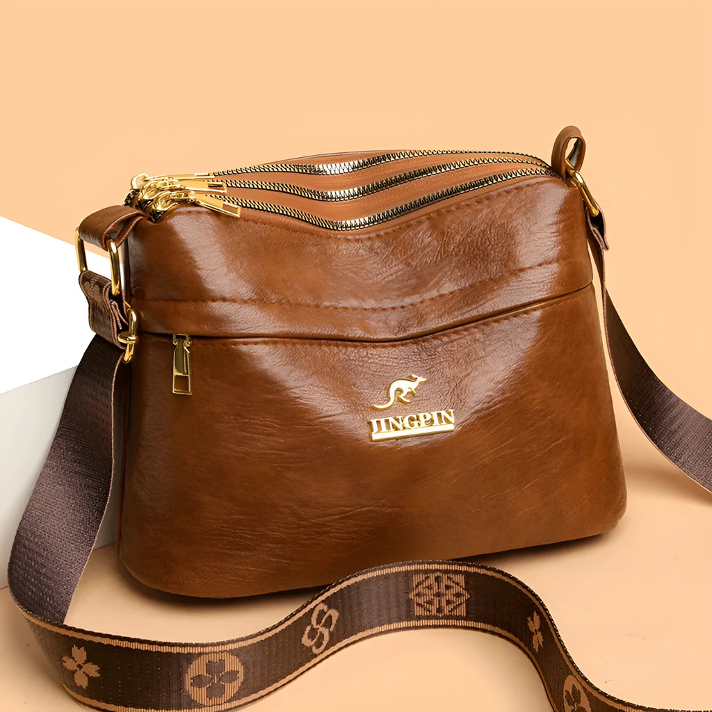 Large capacity multi compartment cross body bag in brown PU with sandwich pocket and sewing thread detail