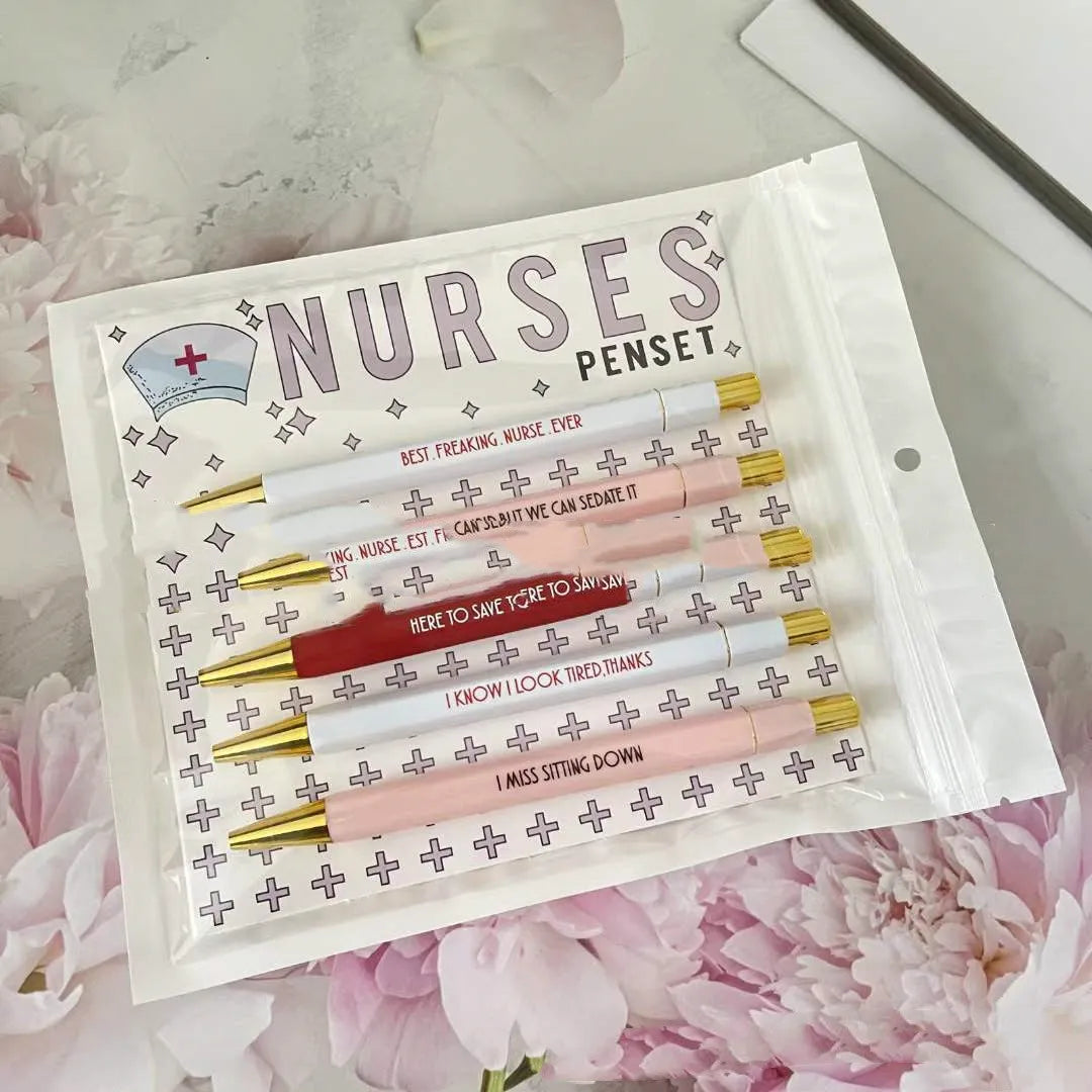 Five nurse-themed retractable ballpoint pens with humorous medical prints arranged together