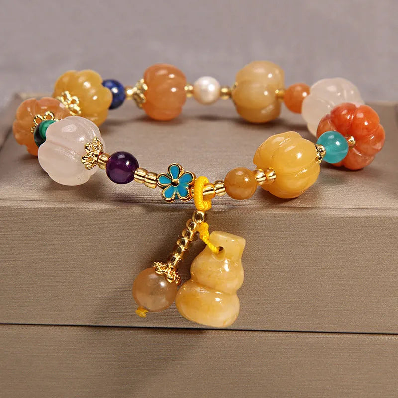 Yellow agate crystal bead bracelet on a gold silk cord with an adjustable metal clasp.