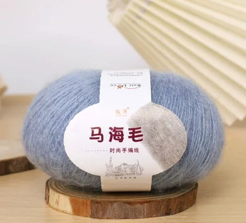 Ball of mohair yarn for DIY scarf knitting in one of 34 colours, including white, pink, blue, and green.