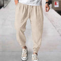 Men's loose-fit light green cotton casual trousers with a banded ankle cuff on a plain background.