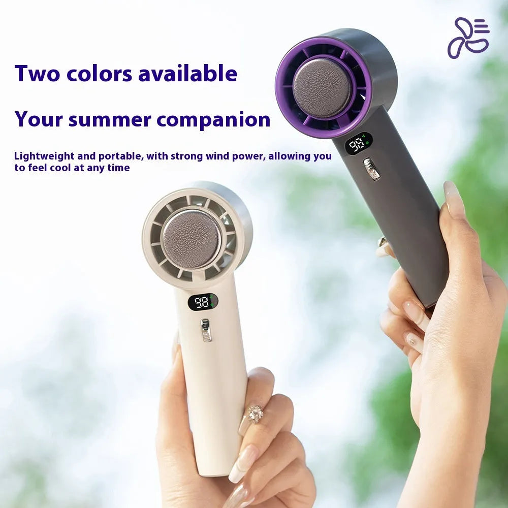 White portable handheld turbo fan with cooling function and display, shown on a table.
