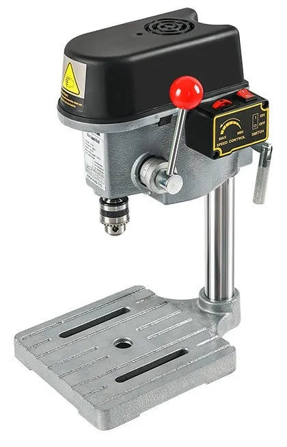 Mini bench drill and milling machine with heavy duty bench pliers on a workbench.